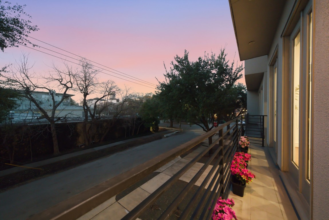 1405 Vermont Street, Unit A Houston, TX 77006 - Photo 21 of 46 Accessed through three sets of elegant French doors, this oversized private balcony offers a sophisticated seating area with a gas connection for effortless outdoor enjoyment. Sleek metal railings and designer tile flooring overlook the quiet streetscape, while the prime Inner Loop location at 1405 Vermont Street #A provides a serene transition between the luxury interiors and the vibrant neighborhood.