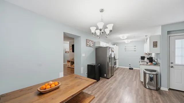 a view of a kitchen with a sink and refrigerator