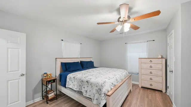a bedroom with a bed and a chandelier