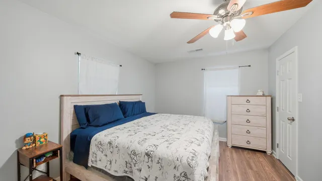 a bedroom with a bed and a chandelier