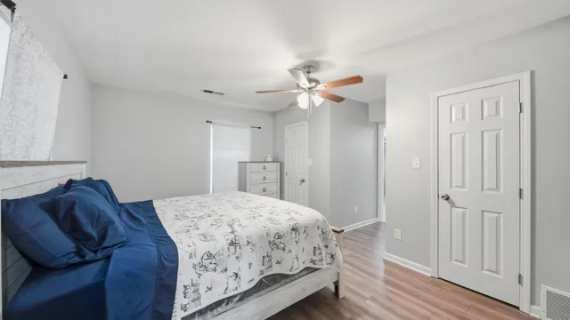 a bedroom with a bed and a chandelier