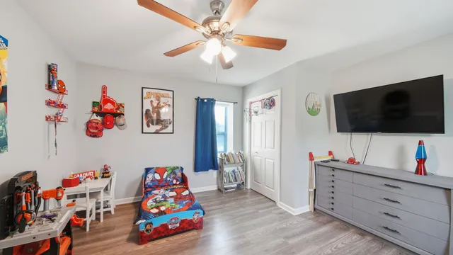 a living room with baby toys and flat screen tv