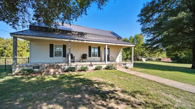 a view of a porch with chairs and backyard