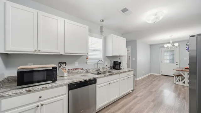 a kitchen with a sink a stove and cabinets