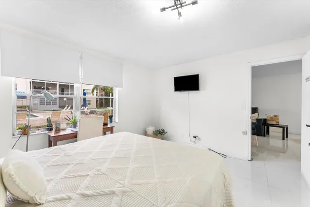 a large white bed in a white room