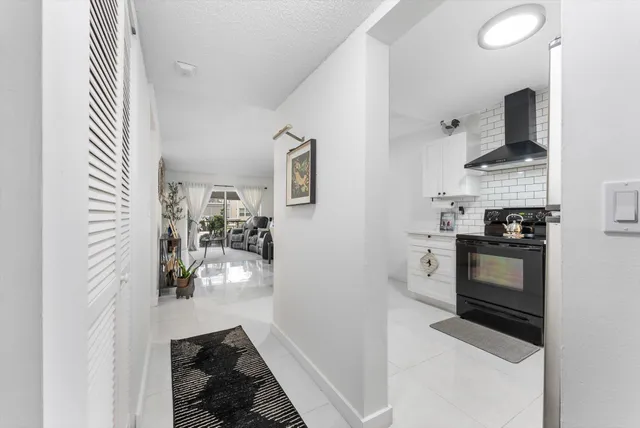 a kitchen with cabinets and a stove