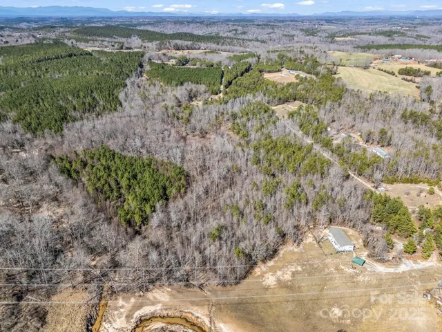 a view of a field with a forest