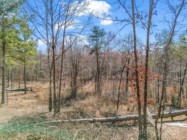 a view of a backyard with table and chairs