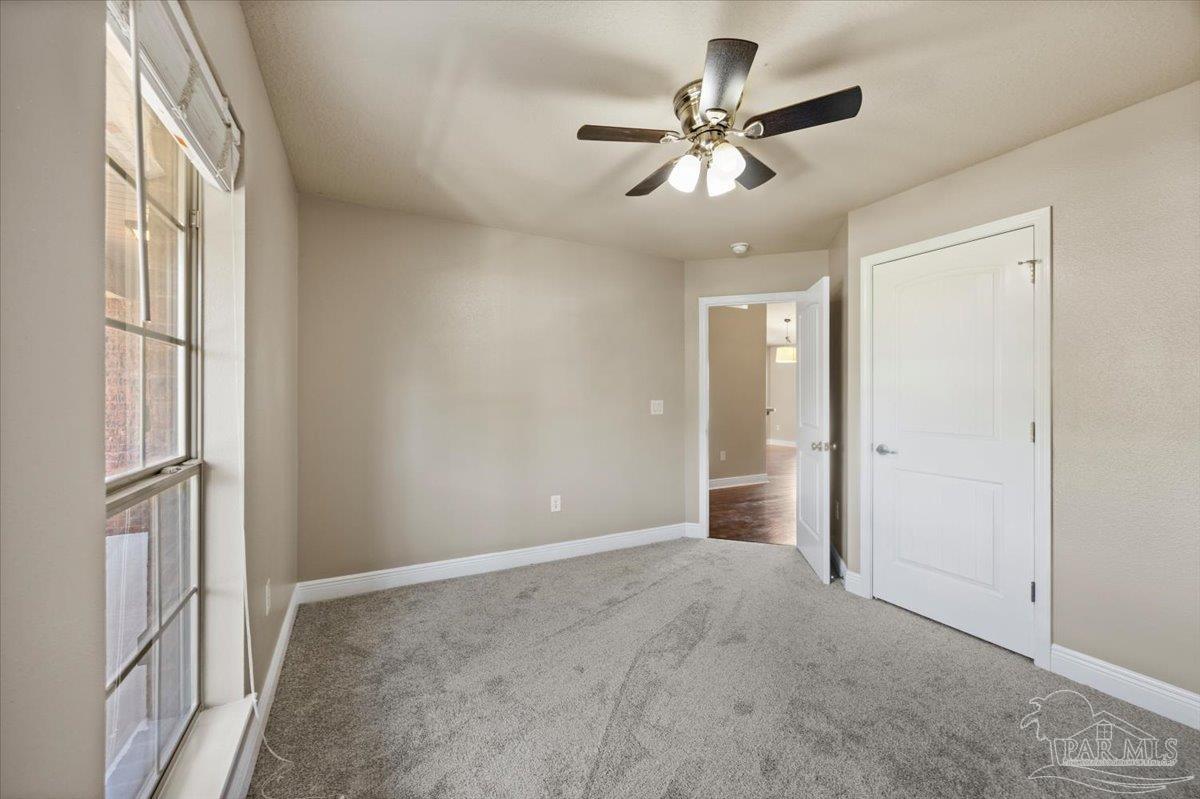 4015 Berry Circle Pace, FL 32571 - Photo 26 of 48 a view of an empty room with a chandelier fan