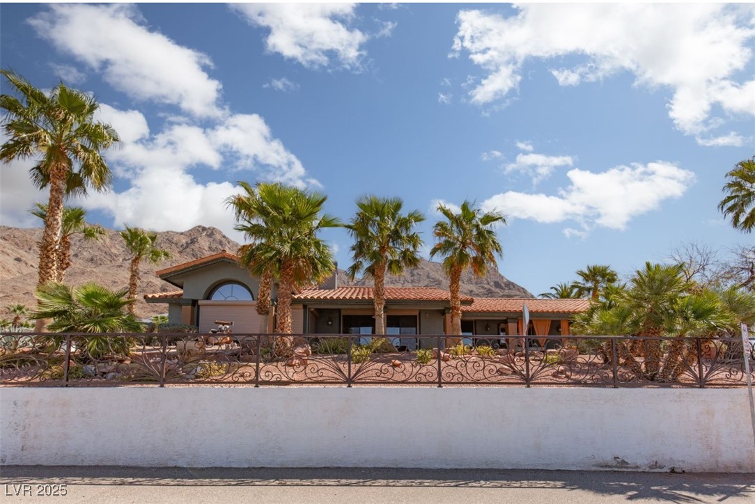 440 Probst Way Las Vegas, NV 89110 - Photo 1 of 42 View of front of home featuring a fenced front yard, stucco siding, a tile roof, and a mountain view