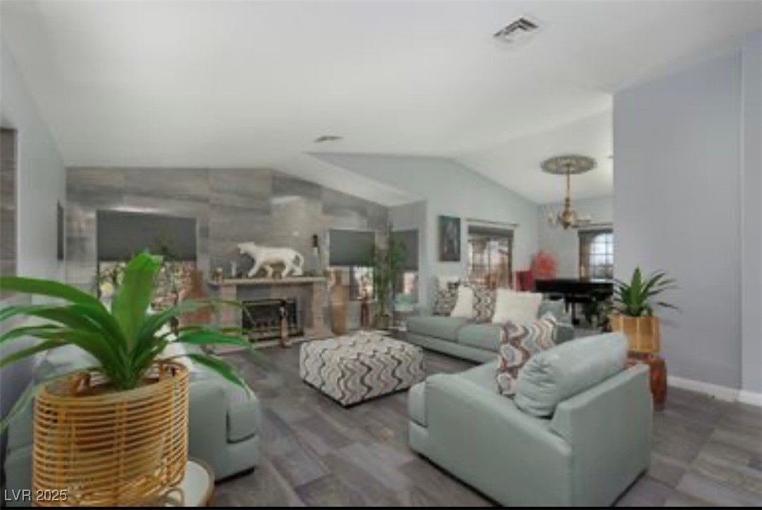 440 Probst Way Las Vegas, NV 89110 - Photo 14 of 42 Living room featuring lofted ceiling, a fireplace, and wood finished floors