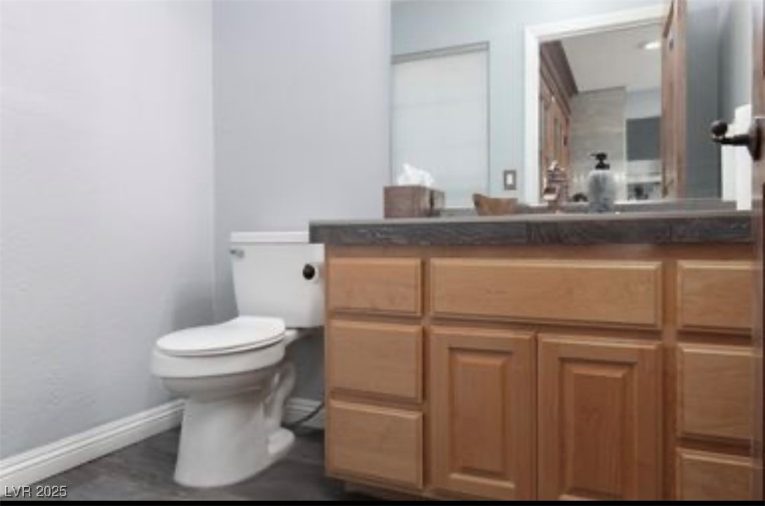 440 Probst Way Las Vegas, NV 89110 - Photo 21 of 42 Half bathroom with vanity and dark wood-type flooring