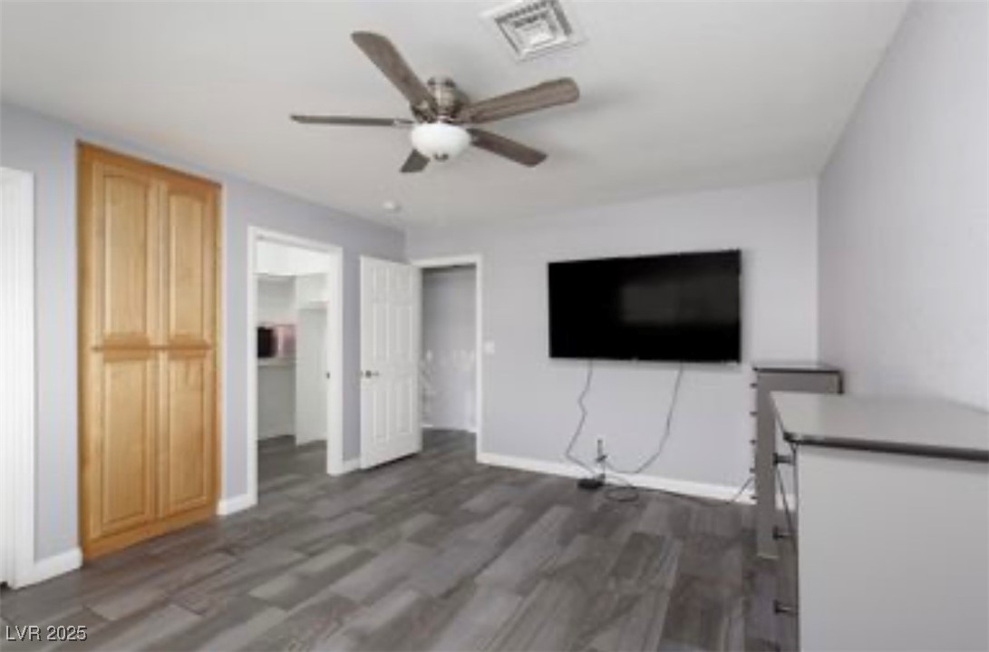 440 Probst Way Las Vegas, NV 89110 - Photo 28 of 42 Unfurnished living room featuring dark wood-style flooring and a ceiling fan