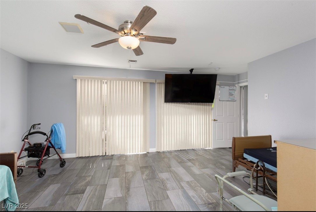 440 Probst Way Las Vegas, NV 89110 - Photo 30 of 42 Unfurnished living room with ceiling fan and wood finish floors