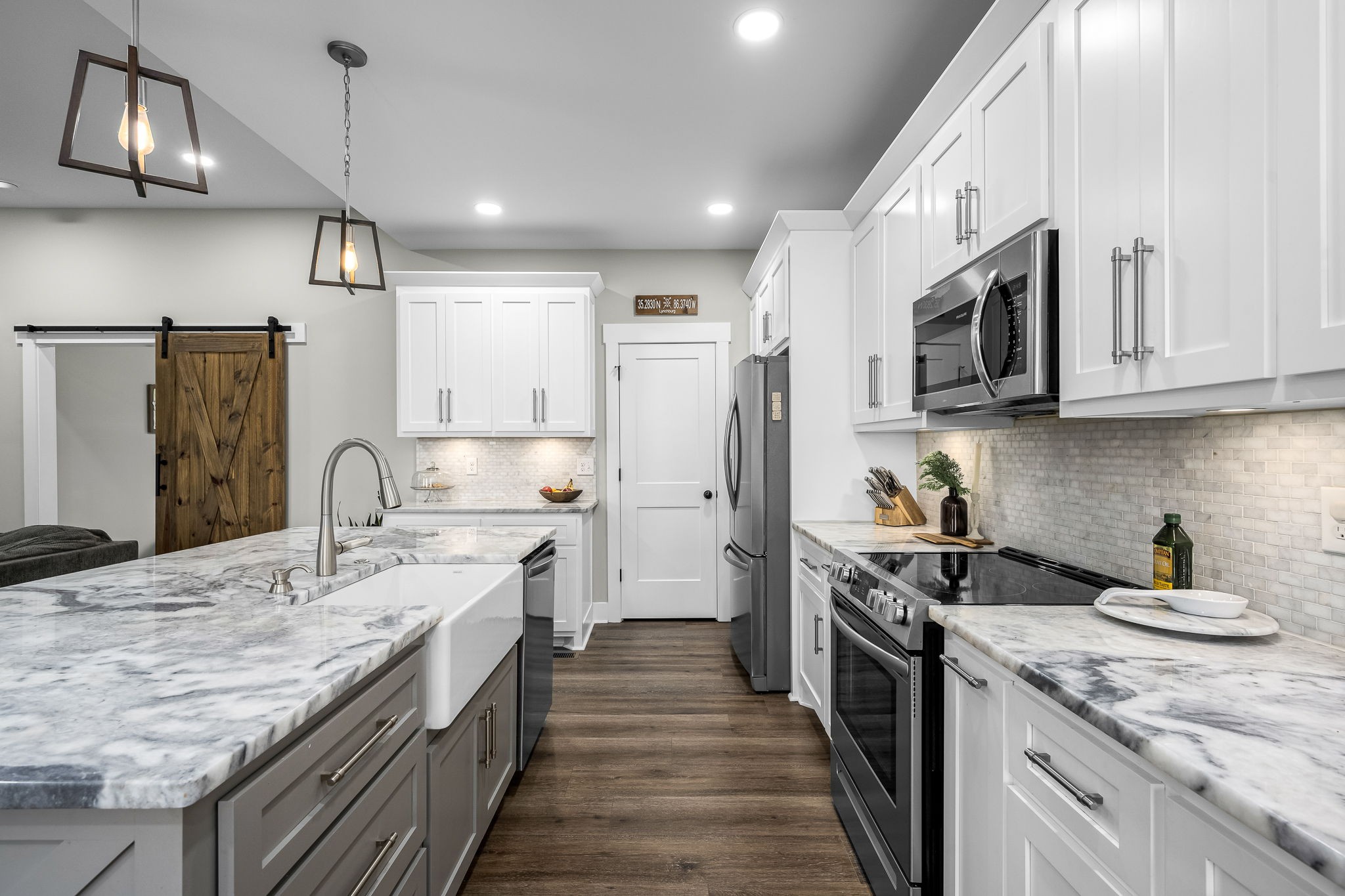 1689 Ridgeview Run Lynchburg, TN 37352 - Photo 19 of 67 a kitchen with stainless steel appliances granite countertop a sink a stove and a wooden floors