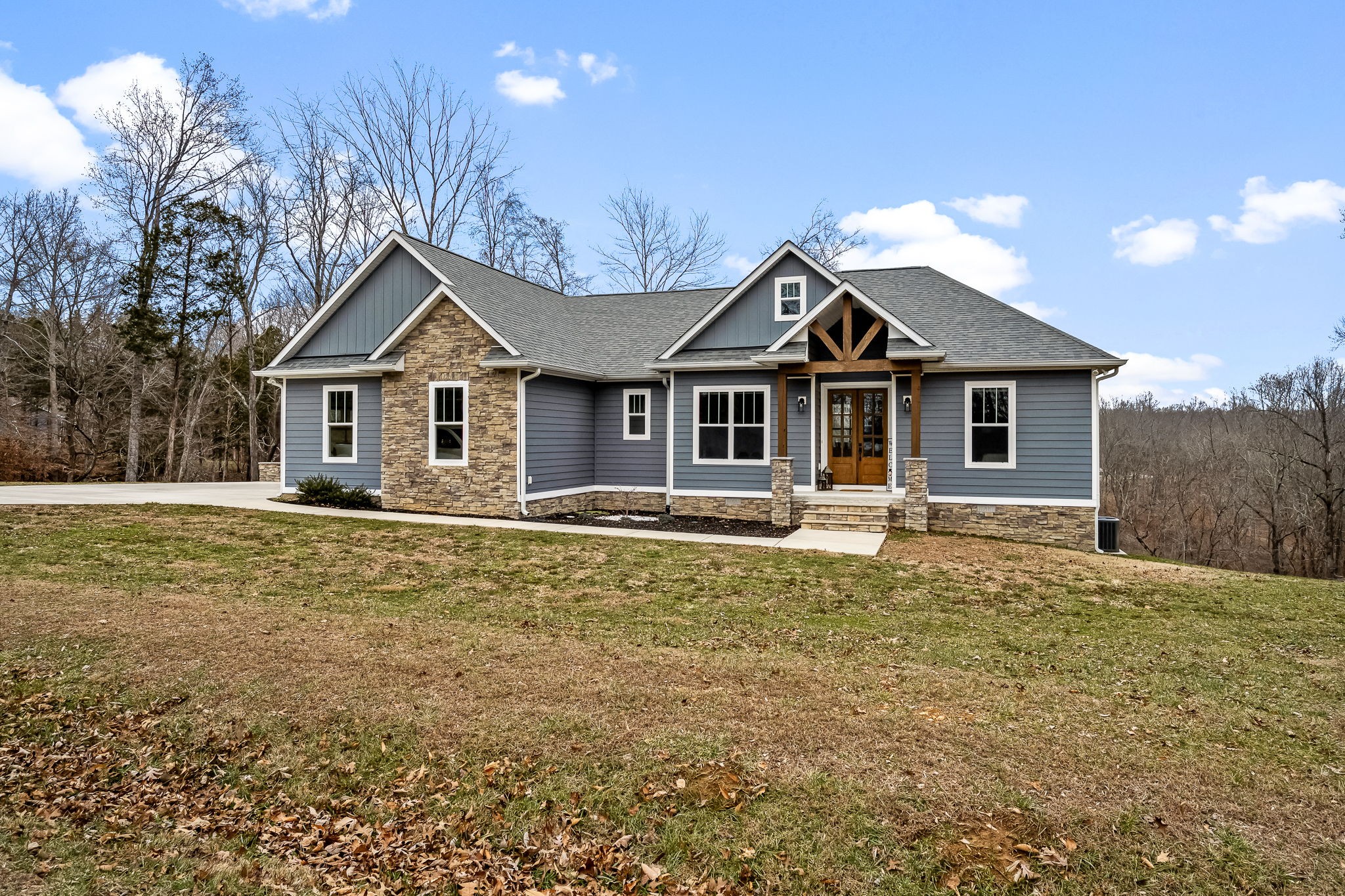 1689 Ridgeview Run Lynchburg, TN 37352 - Photo 9 of 67 a front view of a house with a garden and trees