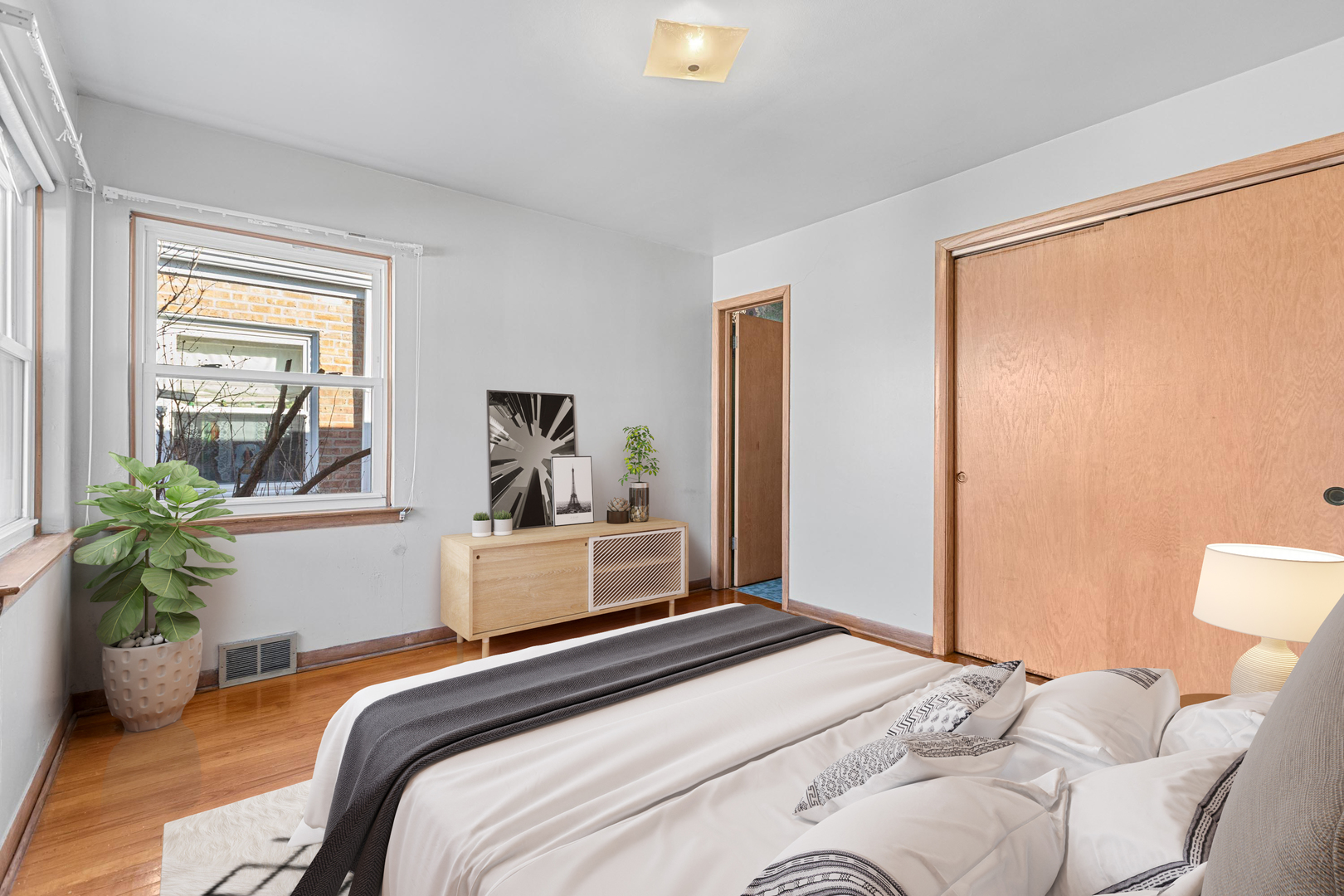2204 Hainsworth Avenue North Riverside, IL 60546 - Photo 11 of 17 a bedroom with a bed and a potted plant