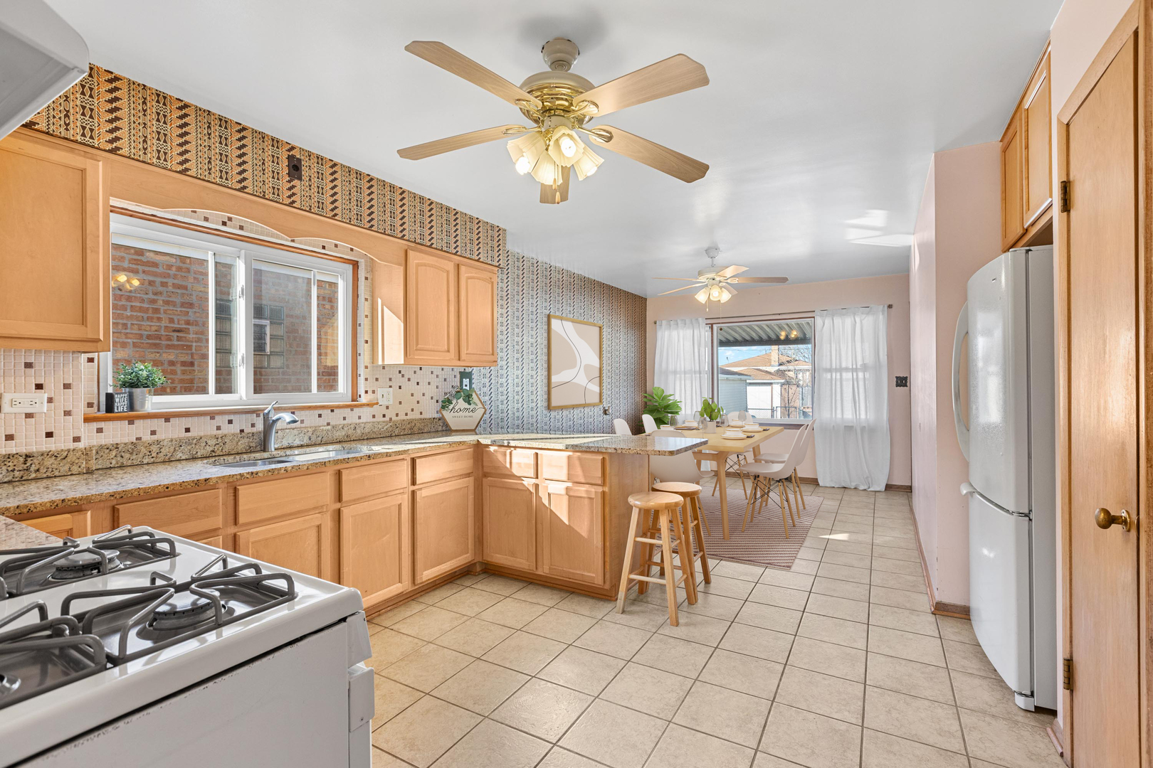 2204 Hainsworth Avenue North Riverside, IL 60546 - Photo 4 of 17 a kitchen with stainless steel appliances granite countertop a stove top oven a sink a dining table and chairs