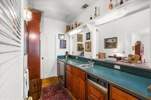 a kitchen with stainless steel appliances kitchen island granite countertop a sink stove and cabinets