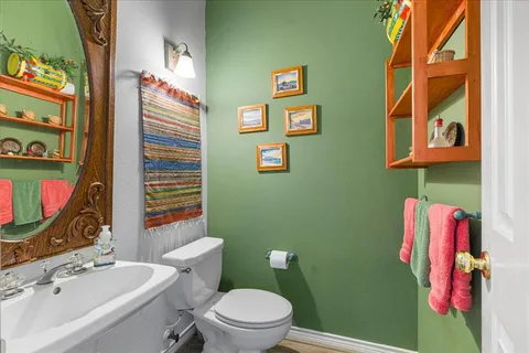 a bathroom with sink toilet and shower