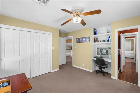 a view of a livingroom with workspace and a window