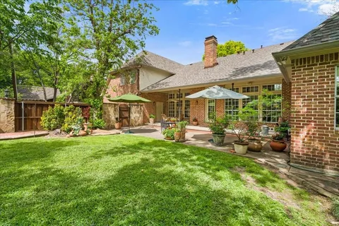a view of a house with backyard porch and sitting area