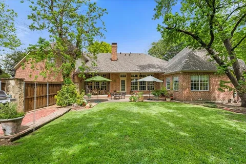 a front view of a house with a garden and patio