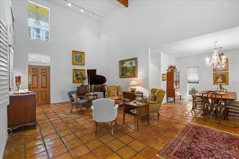 a living room with furniture a dining table and chair with wooden floor