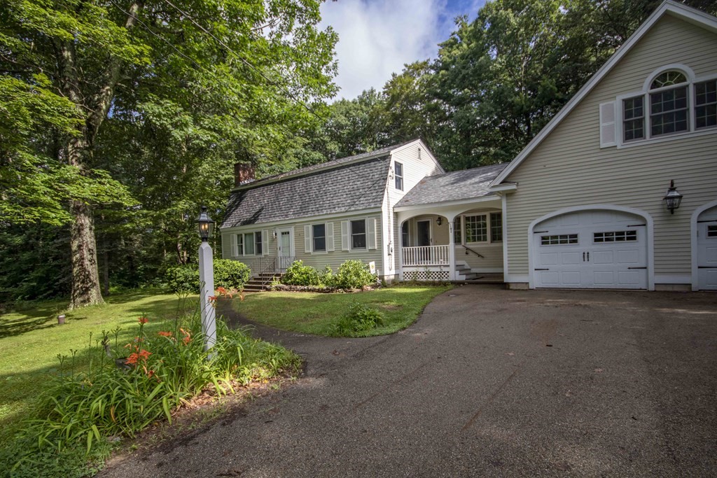 9 Elwood Road Derry, NH 03038 - Photo 1 of 42 a front view of a house with a yard and porch