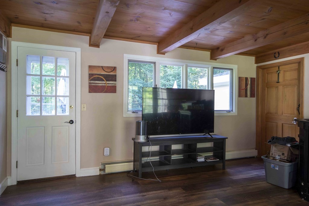 9 Elwood Road Derry, NH 03038 - Photo 14 of 42 a living room with flat screen tv and wooden floor