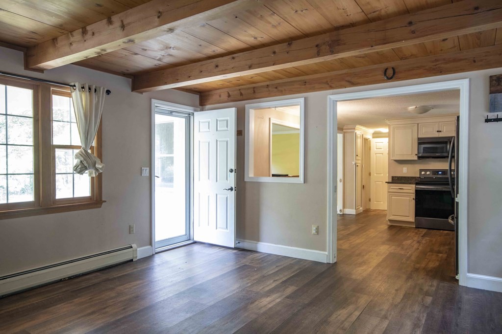 9 Elwood Road Derry, NH 03038 - Photo 15 of 42 a view of a big room with wooden floor and windows
