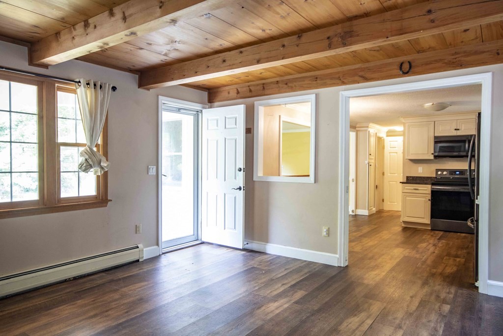 9 Elwood Road Derry, NH 03038 - Photo 16 of 42 a view of a big room with wooden floor and a kitchen
