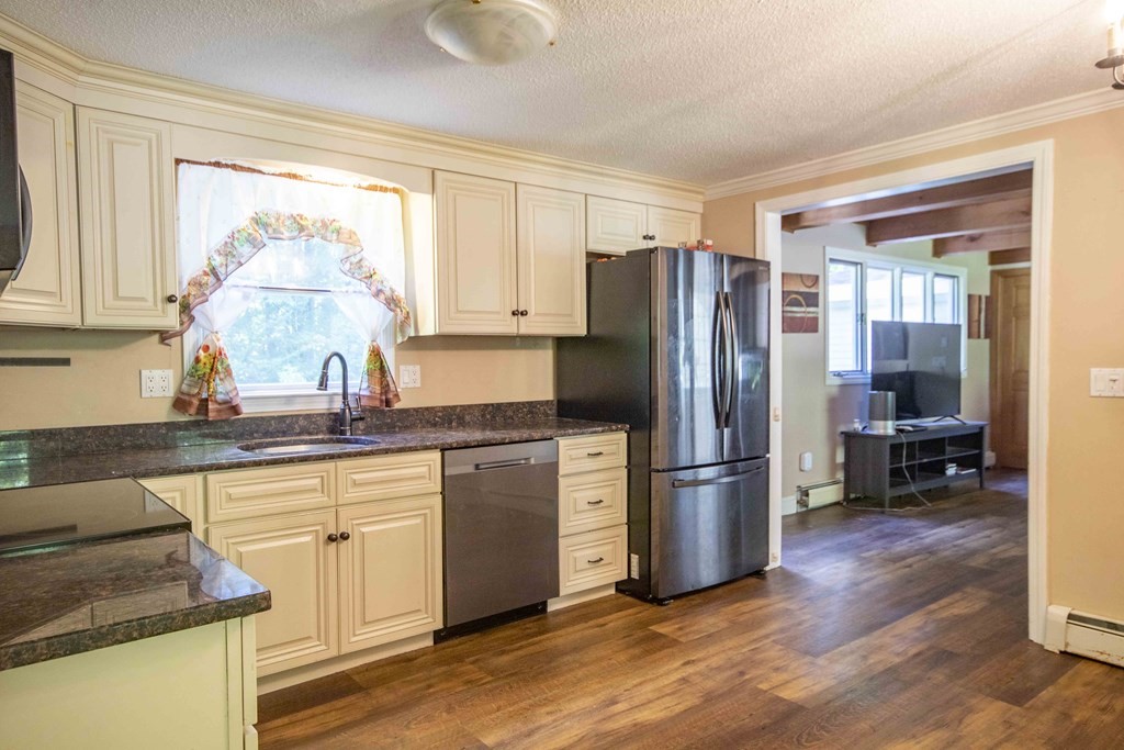 9 Elwood Road Derry, NH 03038 - Photo 21 of 42 a kitchen with stainless steel appliances granite countertop a refrigerator and a sink
