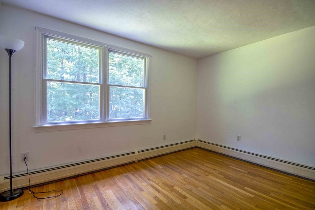 9 Elwood Road Derry, NH 03038 - Photo 37 of 42 a view of empty room with wooden floor and fan