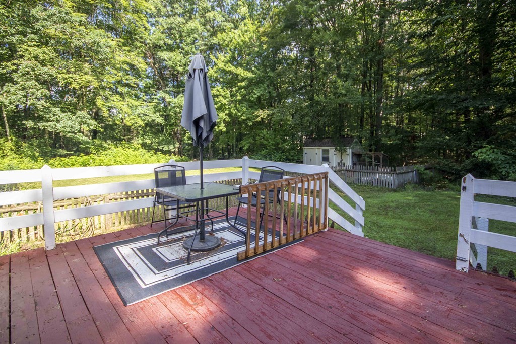 9 Elwood Road Derry, NH 03038 - Photo 5 of 42 a view of a patio with a table and chairs