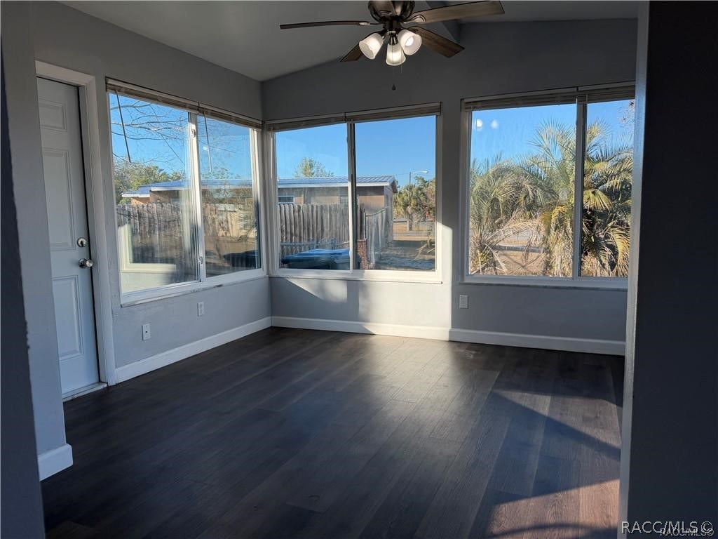 405 Copperfield Road Spring Hill, FL 34606 - Photo 11 of 25 a view of an empty room with wooden floor and a window