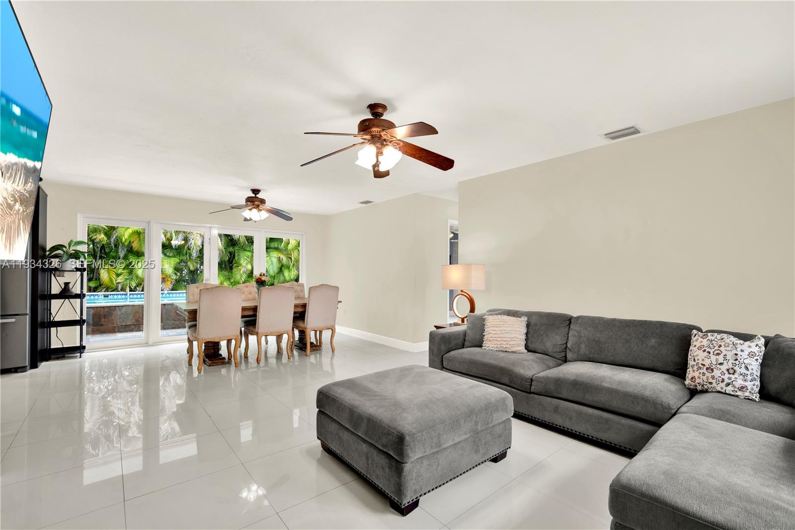 7135 Southwest 19th Terrace Miami, FL 33155 - Photo 11 of 52 a living room with furniture potted plant and a large window
