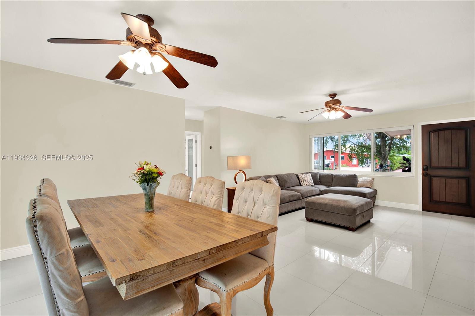 7135 Southwest 19th Terrace Miami, FL 33155 - Photo 12 of 52 a living room with furniture and a chandelier