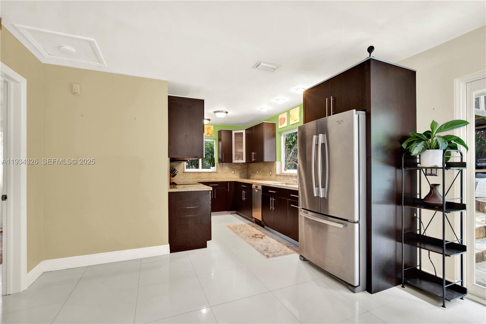 7135 Southwest 19th Terrace Miami, FL 33155 - Photo 18 of 52 a kitchen with a refrigerator and a sink