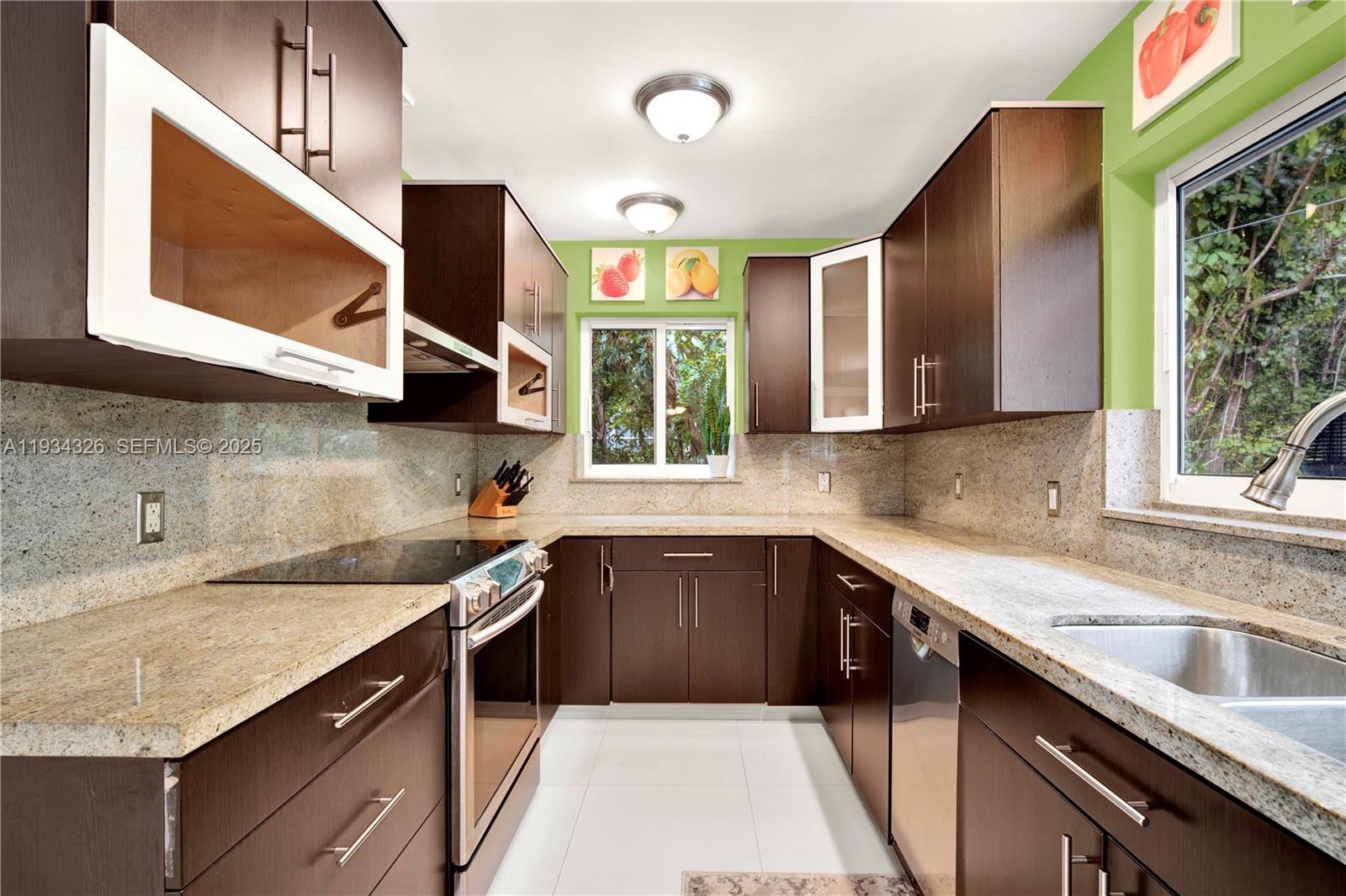 7135 Southwest 19th Terrace Miami, FL 33155 - Photo 20 of 52 a kitchen with a sink stove and microwave
