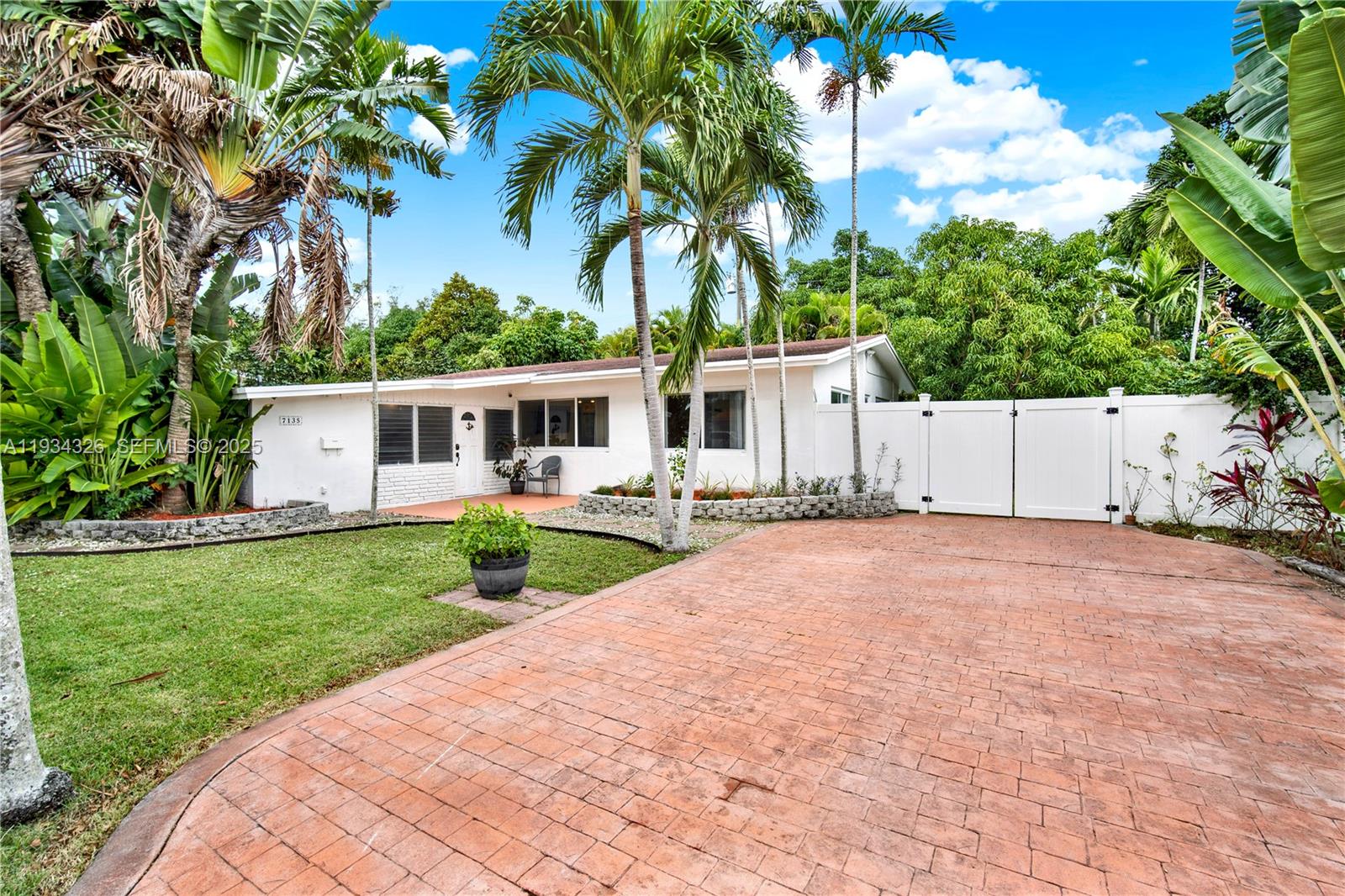7135 Southwest 19th Terrace Miami, FL 33155 - Photo 2 of 52 a front view of house with yard and green space