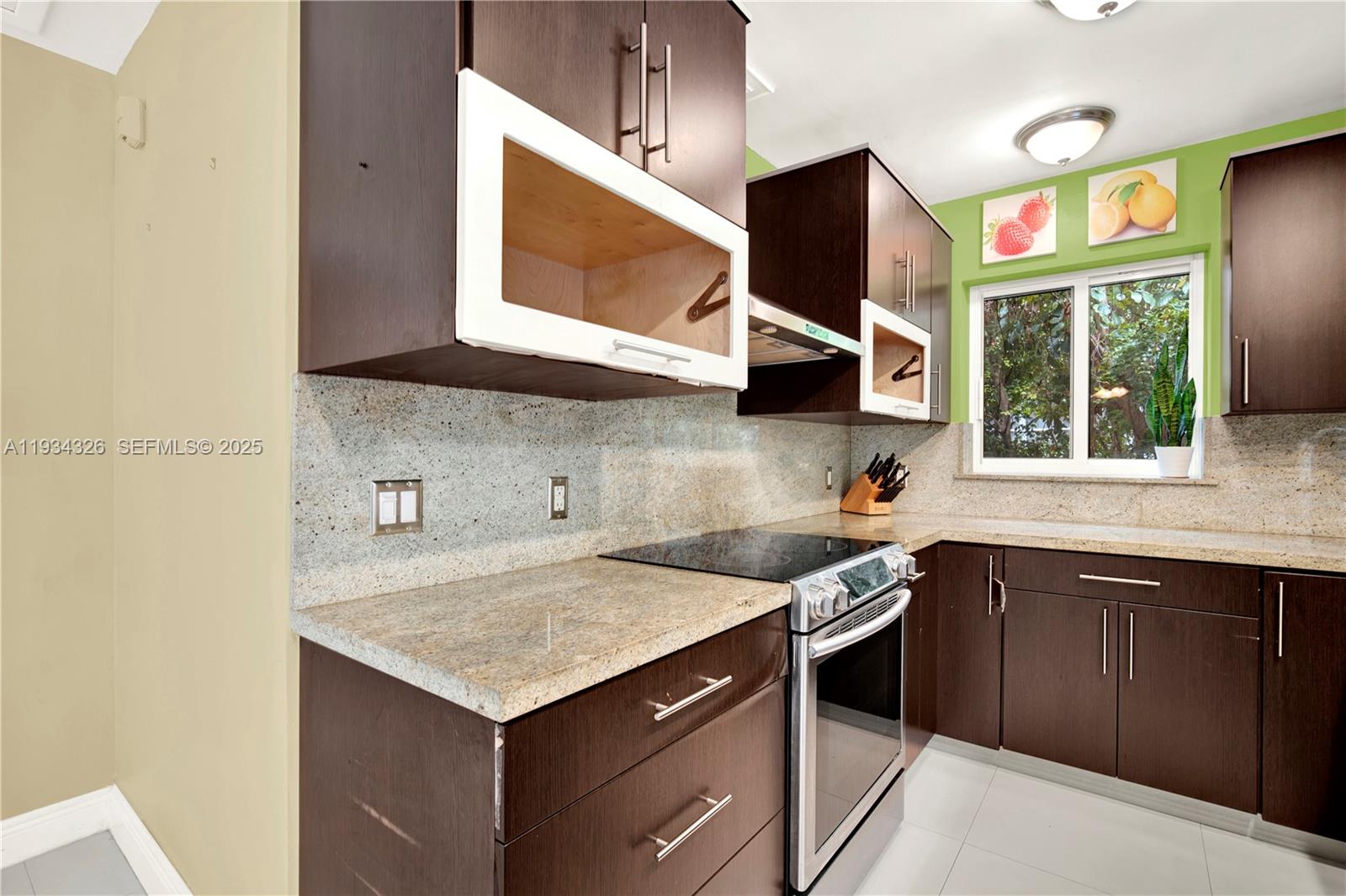 7135 Southwest 19th Terrace Miami, FL 33155 - Photo 22 of 52 a kitchen with a sink stove and microwave