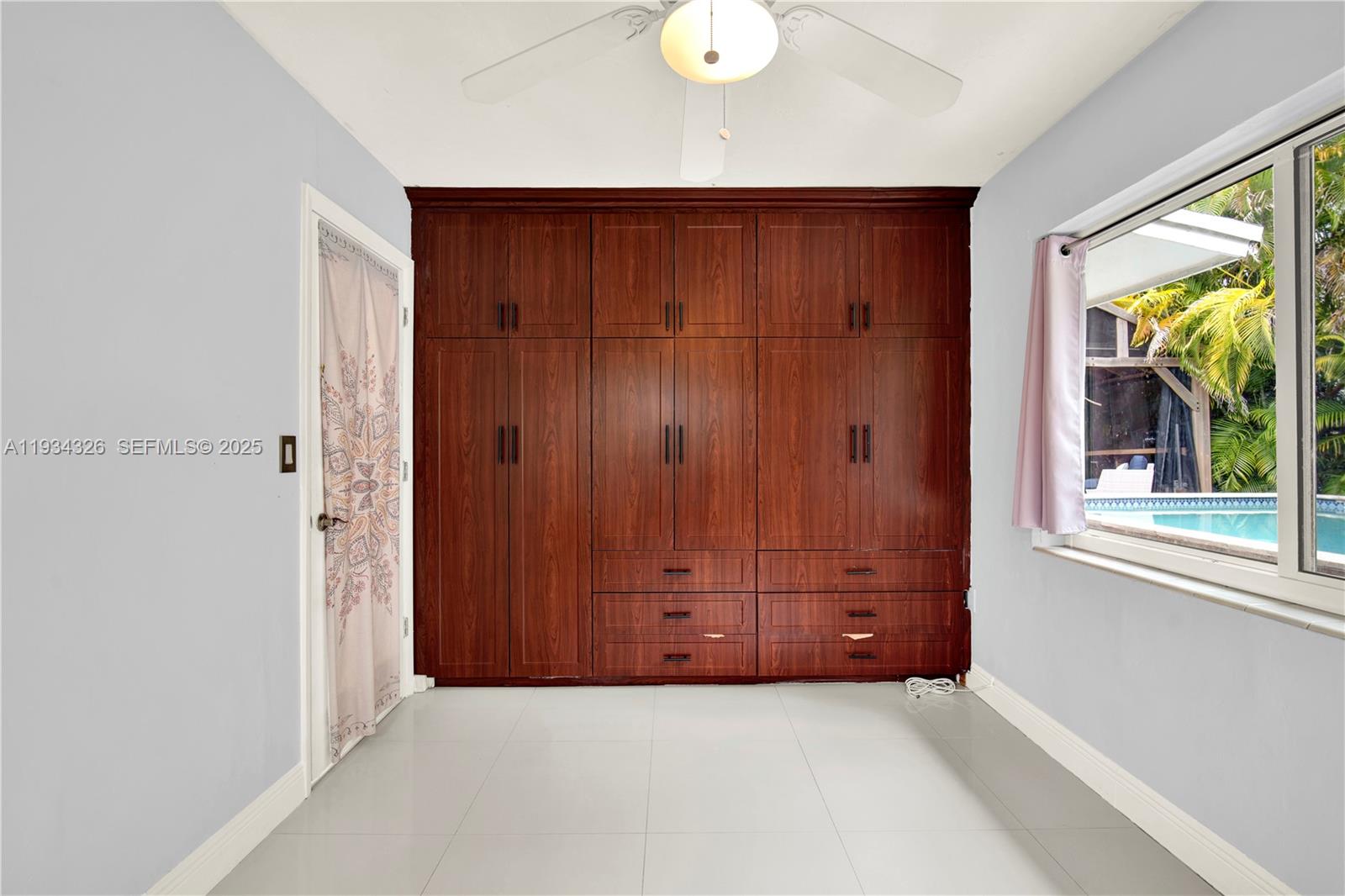7135 Southwest 19th Terrace Miami, FL 33155 - Photo 23 of 52 an empty room with windows and closet