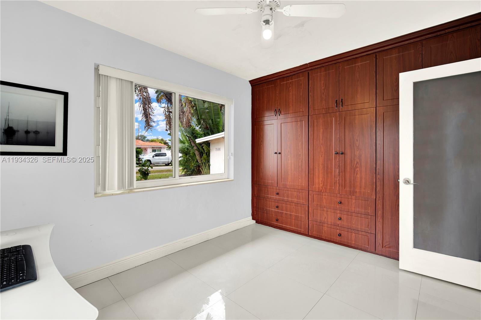 7135 Southwest 19th Terrace Miami, FL 33155 - Photo 24 of 52 a view of an empty room with window and cabinet