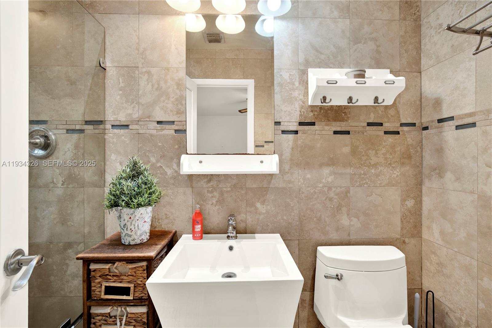 7135 Southwest 19th Terrace Miami, FL 33155 - Photo 25 of 52 a bathroom with a sink a toilet and shower