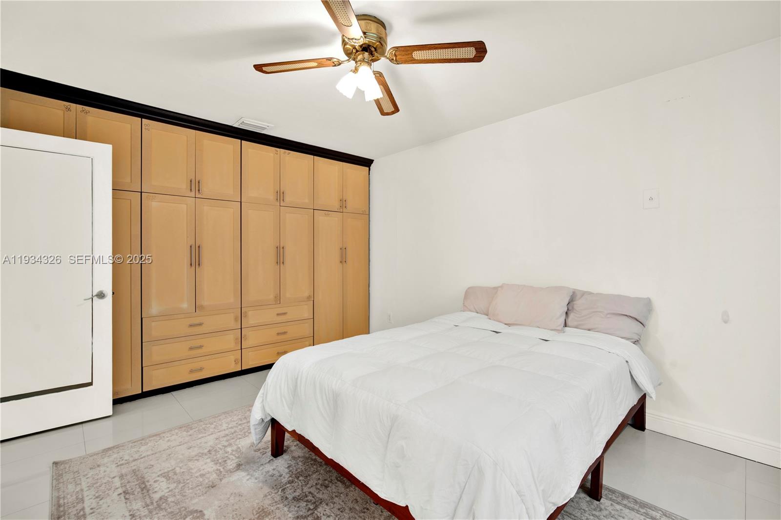 7135 Southwest 19th Terrace Miami, FL 33155 - Photo 26 of 52 a bedroom with a bed a dresser and a chandelier