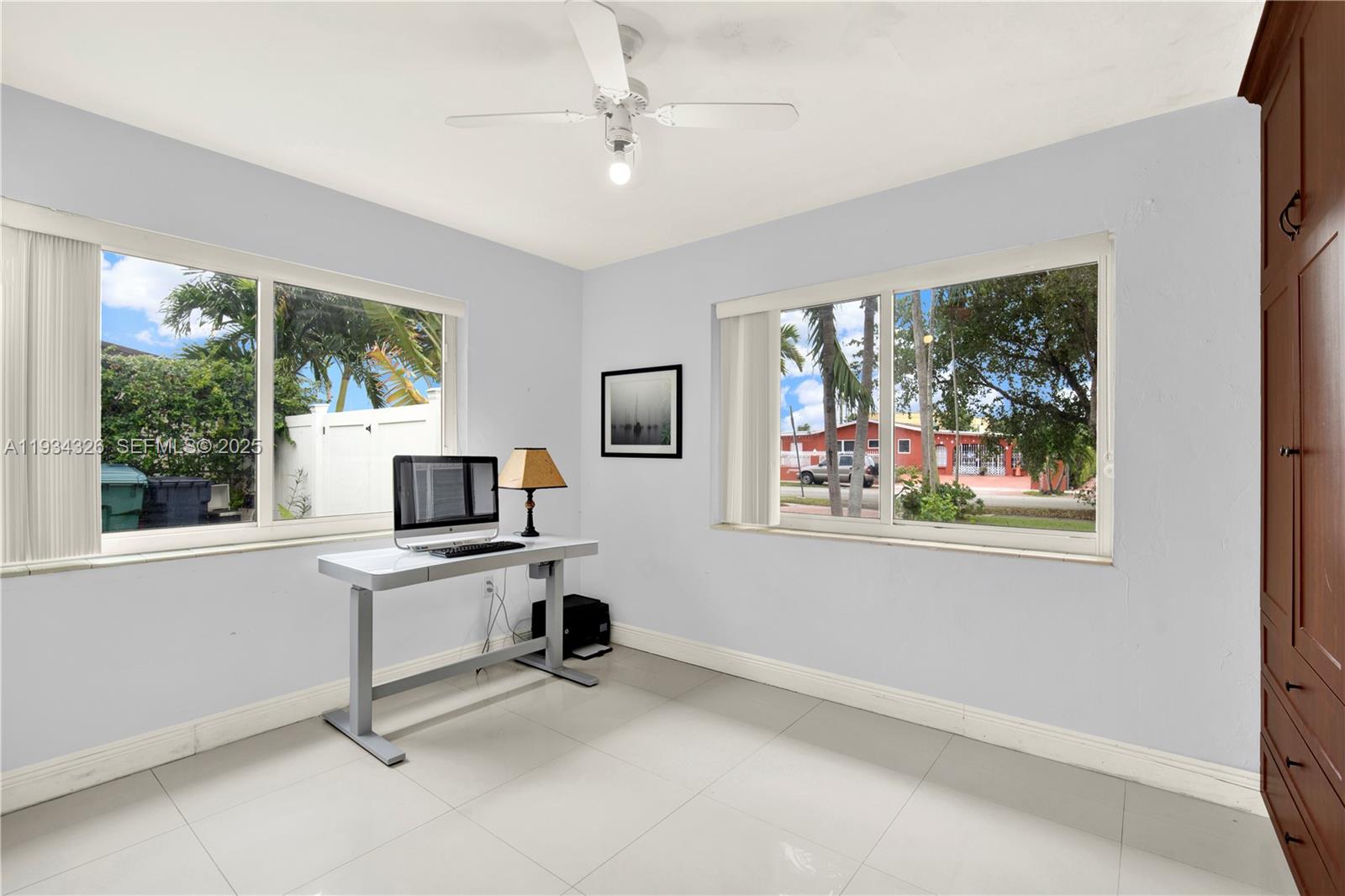 7135 Southwest 19th Terrace Miami, FL 33155 - Photo 28 of 52 a view of a workspace with furniture and a window