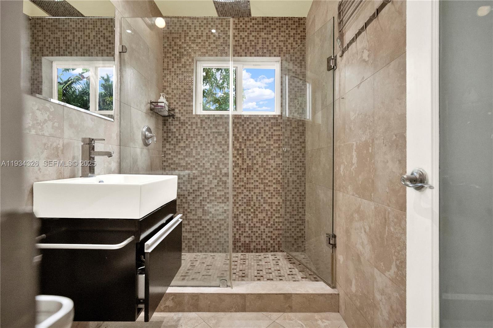 7135 Southwest 19th Terrace Miami, FL 33155 - Photo 29 of 52 a bathroom with a sink a toilet a window and shower