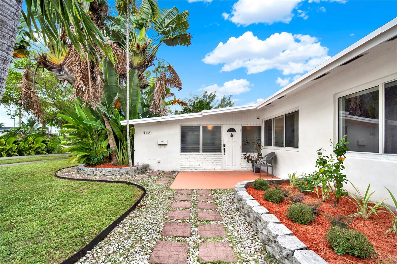 7135 Southwest 19th Terrace Miami, FL 33155 - Photo 3 of 52 a front view of a house with a garden and yard