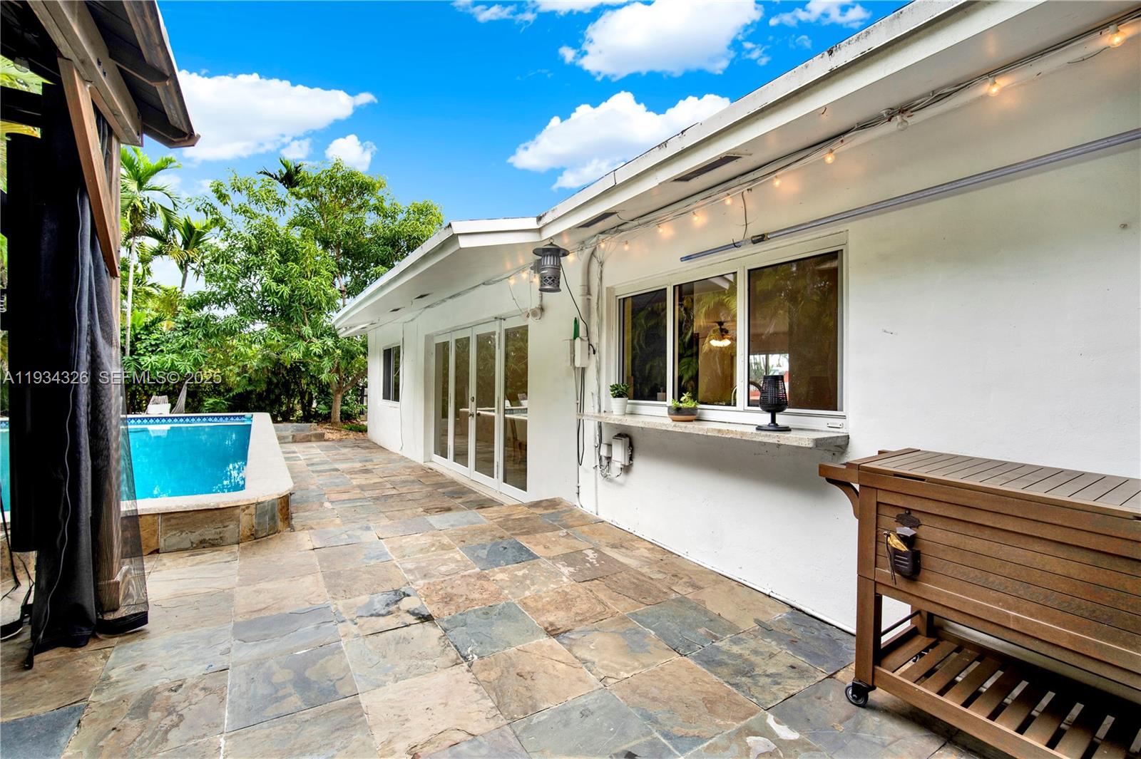7135 Southwest 19th Terrace Miami, FL 33155 - Photo 36 of 52 a view of a patio with couches table and chairs and potted plants